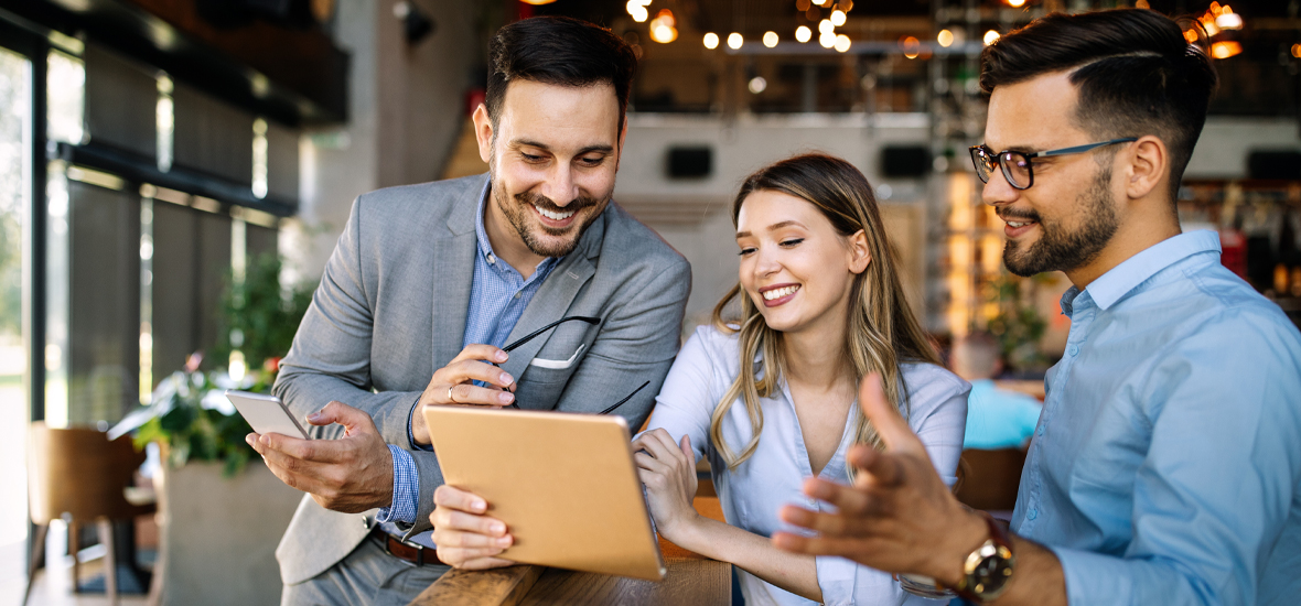 Three young professionals looking at tablet